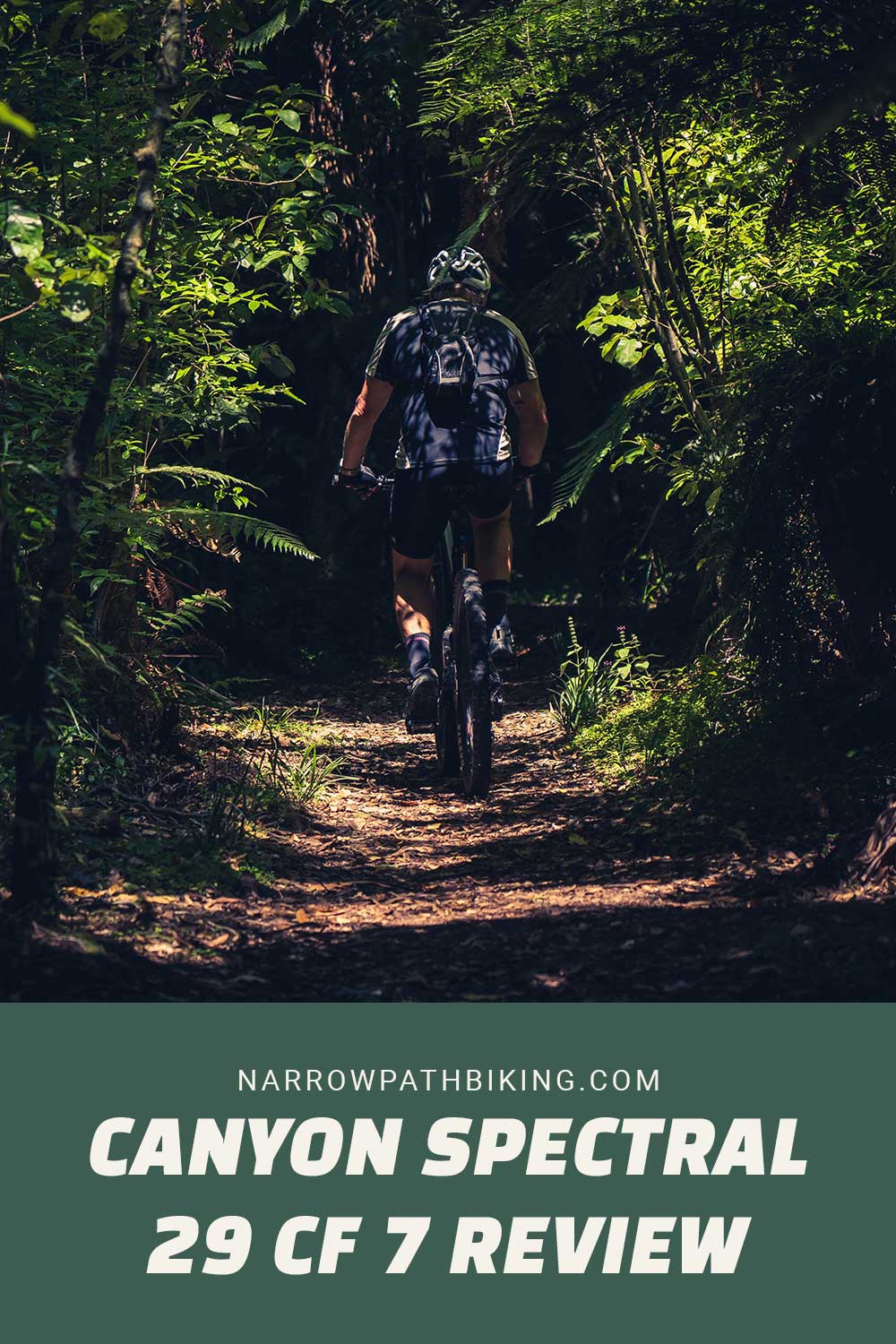 person riding mountain bike on a narrow path in forest - Canyon Spectral 29 CF 7 Review